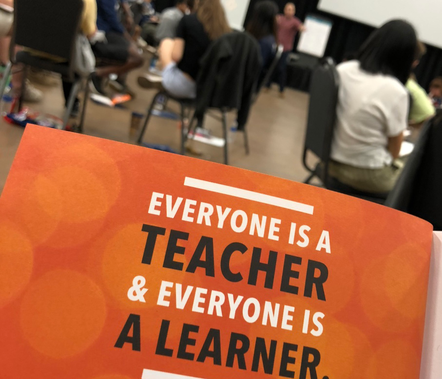 A cover of a participant manual which reads "Everyone is a Teacher & Everyone is a Learner."