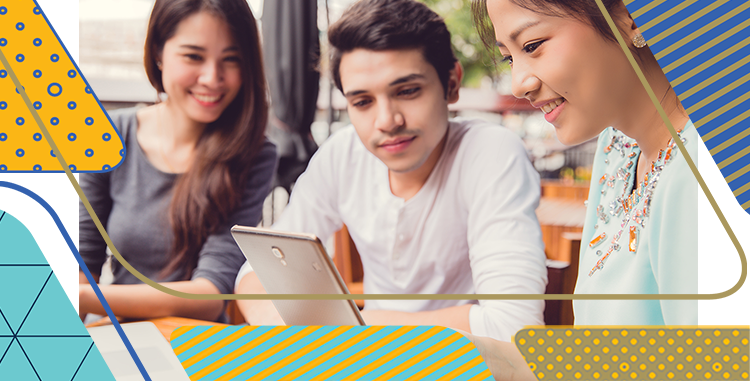 Two female and one male student looking at a computer pad.