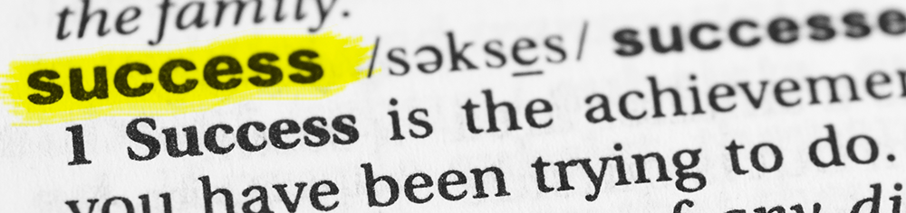 Detail of the English word "success" and its definition from the dictionary.